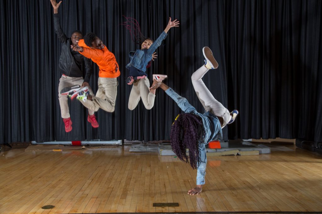 photo by Cecil McDonald Jr. from moment in time exhibition of 8th grade students jumping to signify joy at art on sedgwick